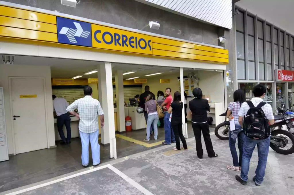 pessoas-em-suas-variadas-vestimentas-esperando-na-fila-do-correios-de-logo-azul-e-amarela-_1_323084-1024x680 Concurso dos Correios 2024: 3.511 Vagas e Salários até R$ 10 Mil